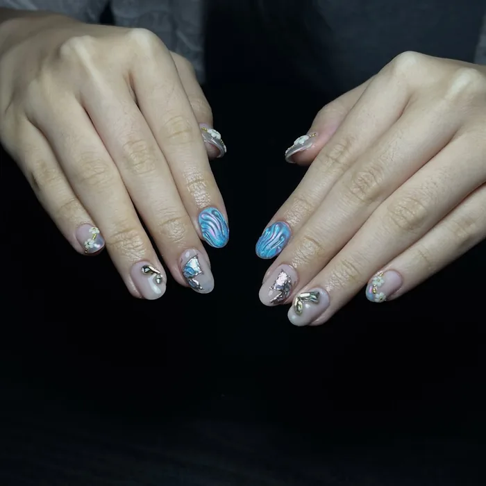 A close view of the blue builder gel set on both hands