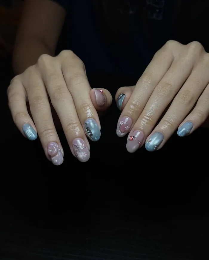 A pale blue cat eye set with hand-painted floral detail